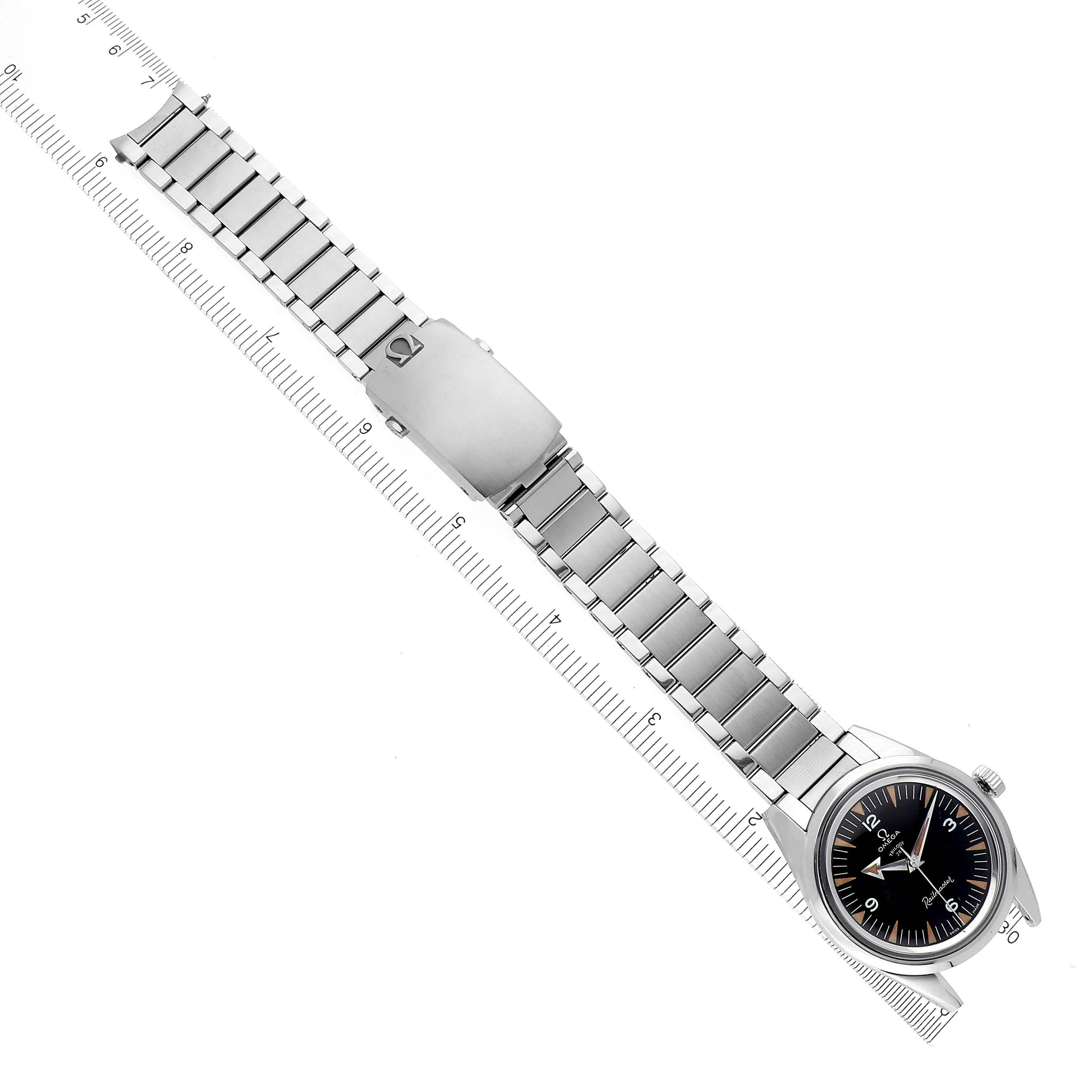 The Omega Museum Men's Stainless Steel Black Dial Men's Stainless Steel Black Dial watch is shown at an overhead angle, displaying the full bracelet, clasp, and face alongside a ruler.