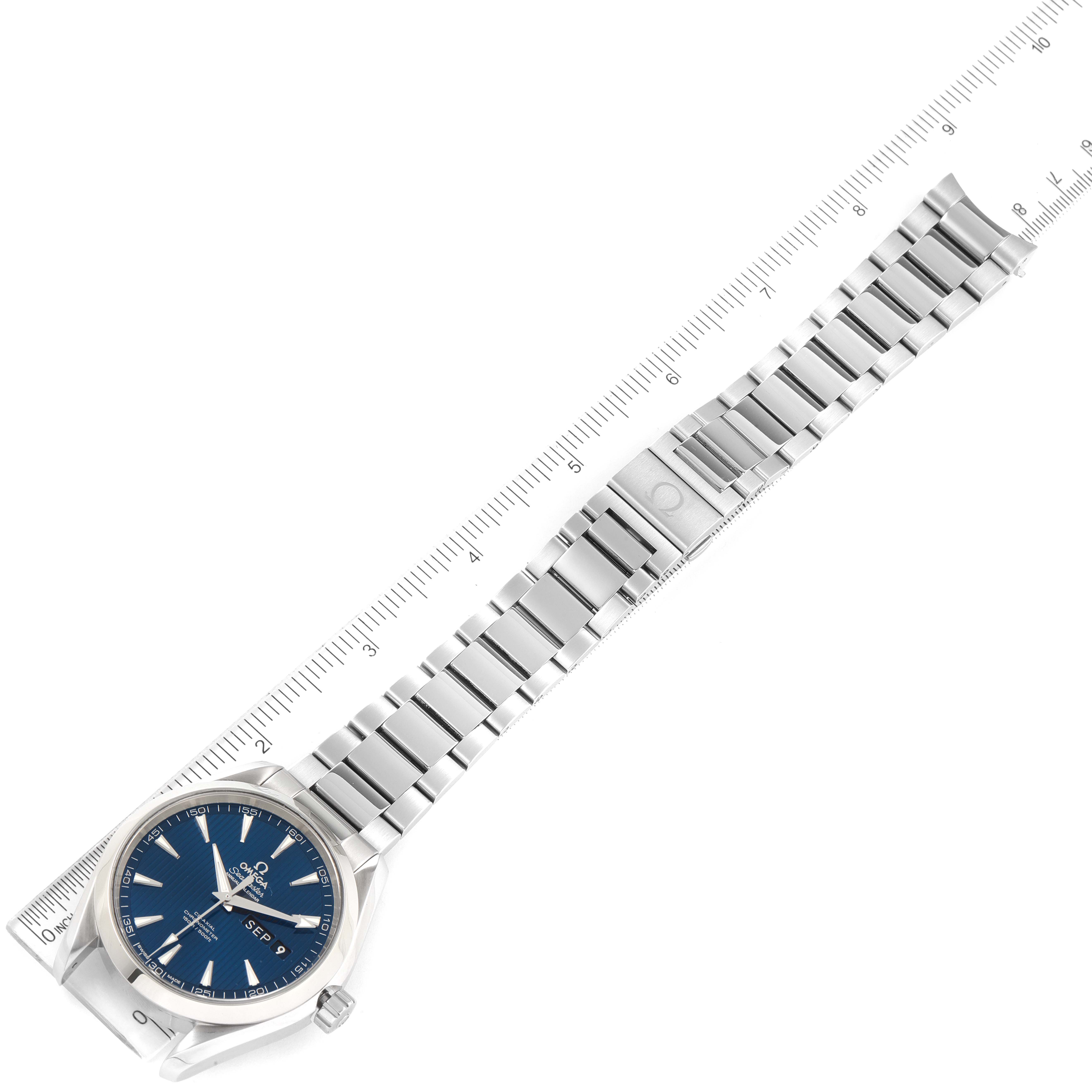 The Omega Aqua Terra 231.10.43.22.03.002 Men's Stainless Steel Blue Dial 231.10.43.22.03.002 Men's Stainless Steel Blue Dial watch is shown from a top-down angle, displaying the face, stainless steel bracelet, and clasp against a ruler.