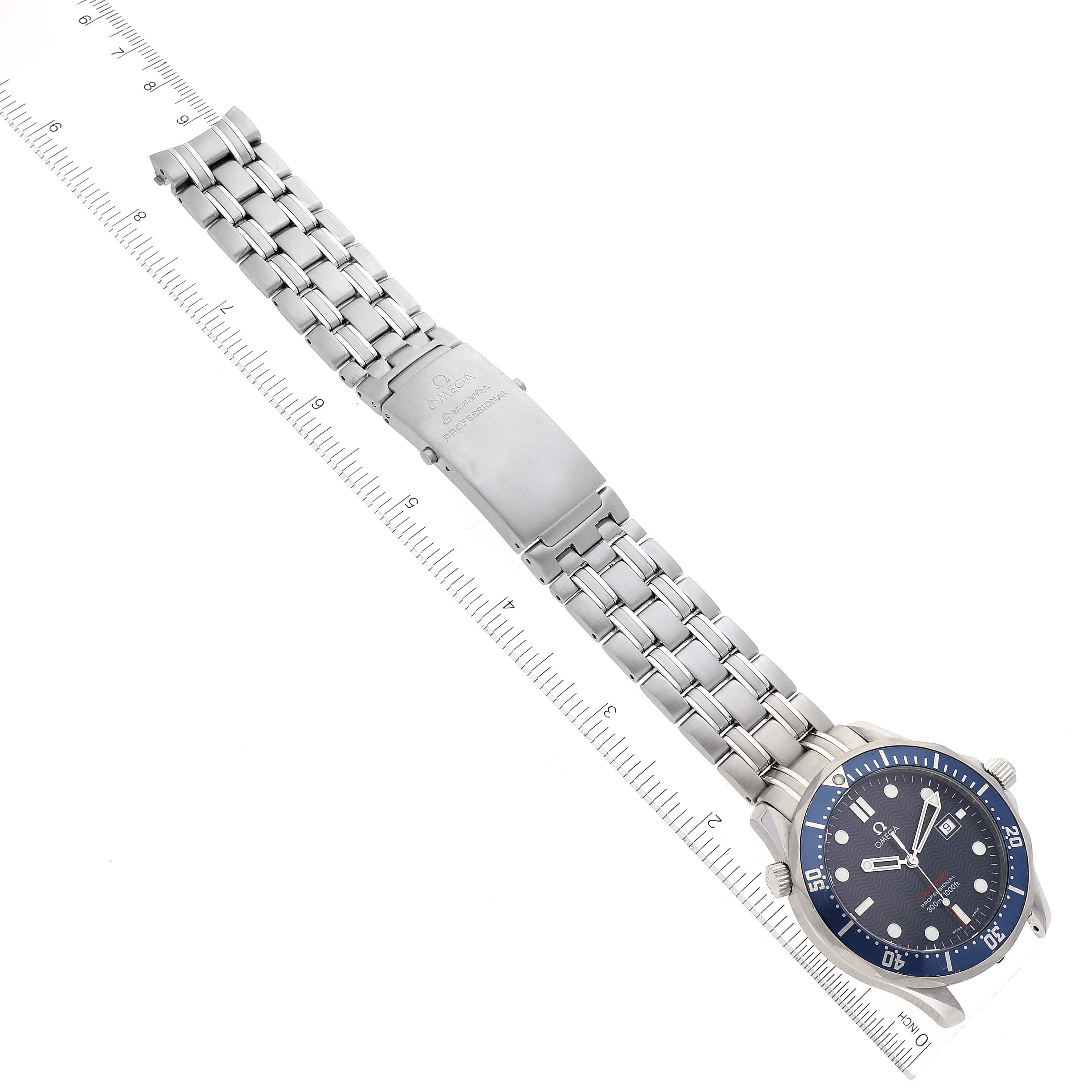 The image shows an Omega Seamaster 2221.80.00 Men's Stainless Steel Blue Dial 2221.80.00 Men's Stainless Steel Blue Dial watch laid flat, displaying its face, bezel, bracelet, and clasp next to a ruler.