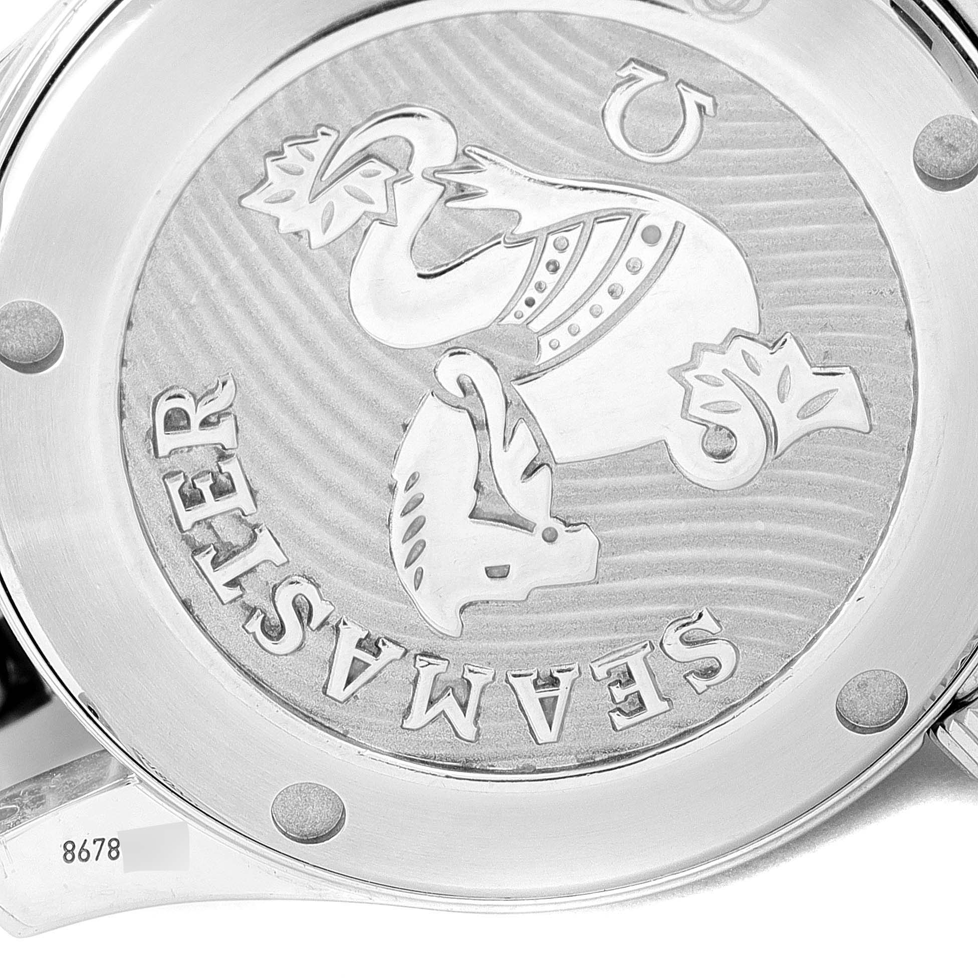 The image shows the case back of an Omega Seamaster 212.30.36.20.03.001 Men's Stainless Steel Blue Dial 212.30.36.20.03.001 Men's Stainless Steel Blue Dial watch, featuring its engraved design logo and surrounding metal parts.