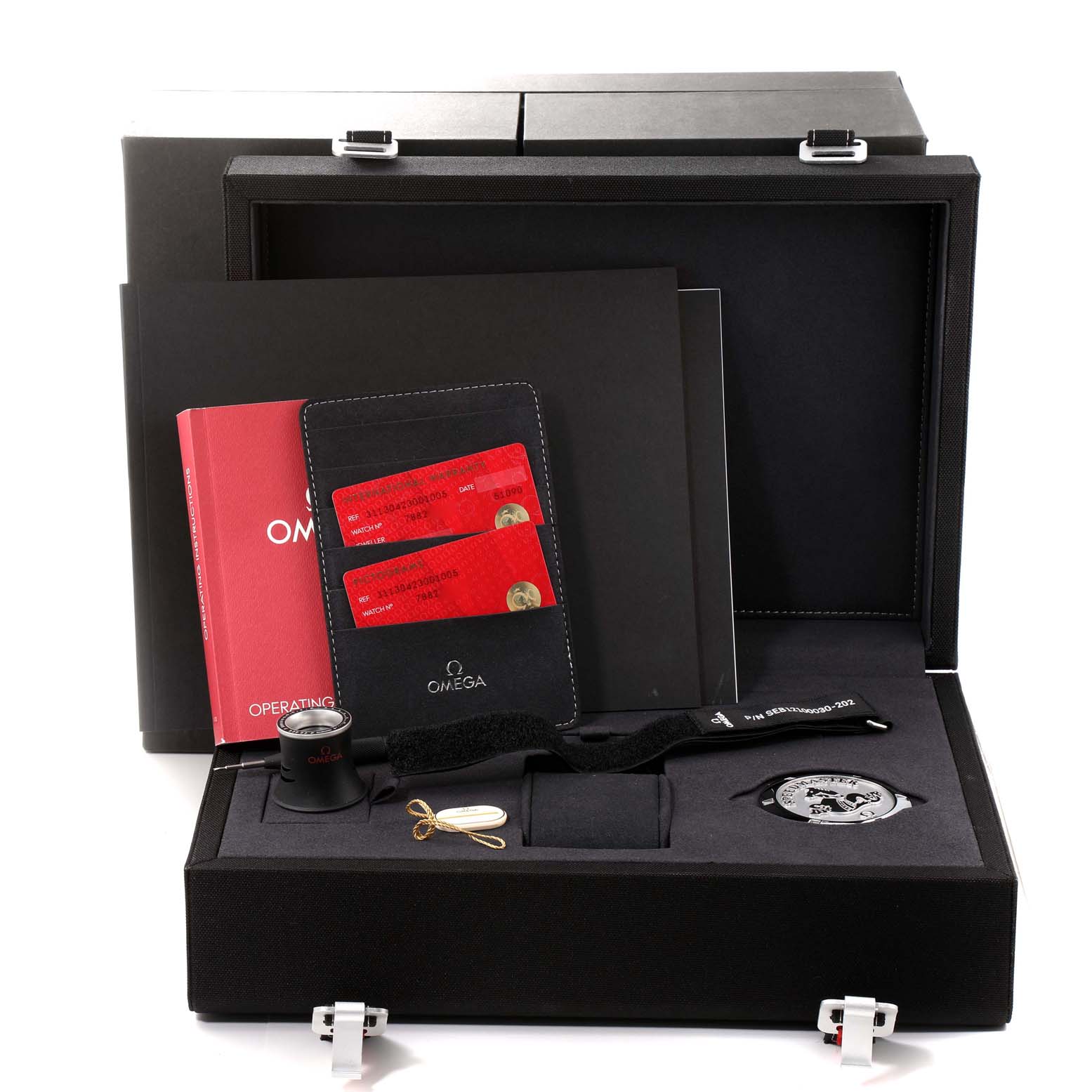 The Omega Speedmaster 311.30.42.30.01.005 Men
s Stainless Steel Black Dial 311.30.42.30.01.005 Men
s Stainless Steel Black Dial watch is shown from the top along with its box, manuals, cards, loupe, strap, and other accessories.