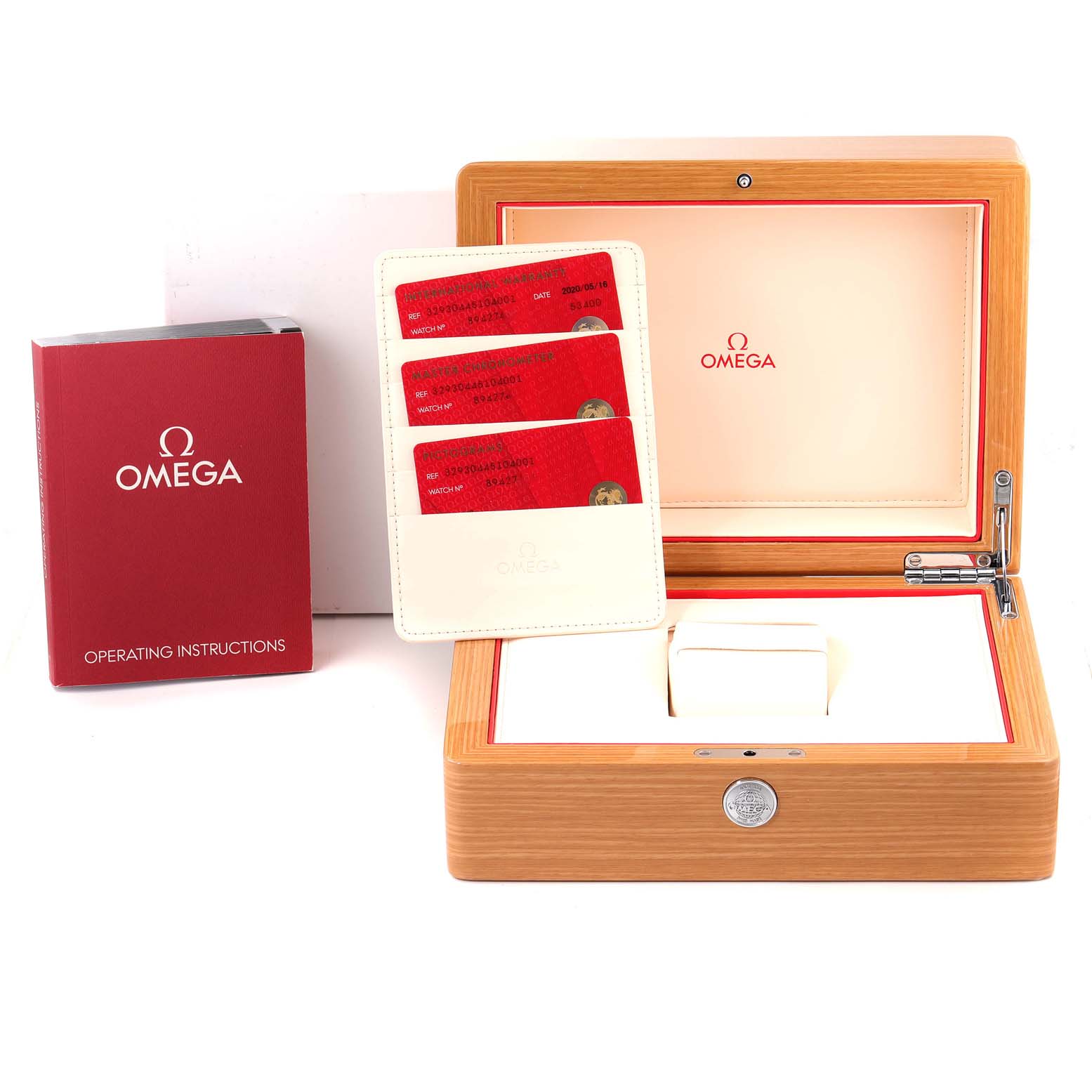 The image shows an Omega Speedmaster 329.30.44.51.04.001 Men
s Stainless Steel White Dial 329.30.44.51.04.001 Men
s Stainless Steel White Dial watch box, operating instructions, and cardholder with red cards, viewed from the front.