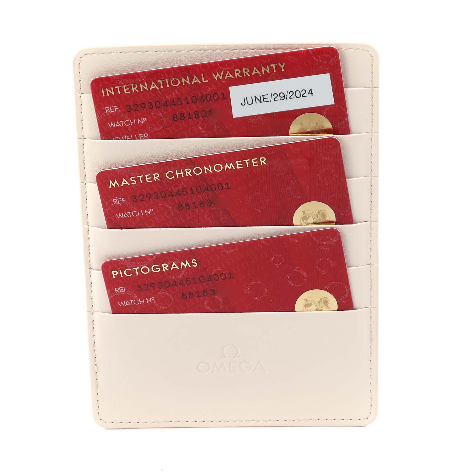 The image shows Omega Speedmaster 329.30.44.51.04.001 Men
s Stainless Steel Silver Dial 329.30.44.51.04.001 Men
s Stainless Steel Silver Dial model warranty cards and documents in a cream cardholder.