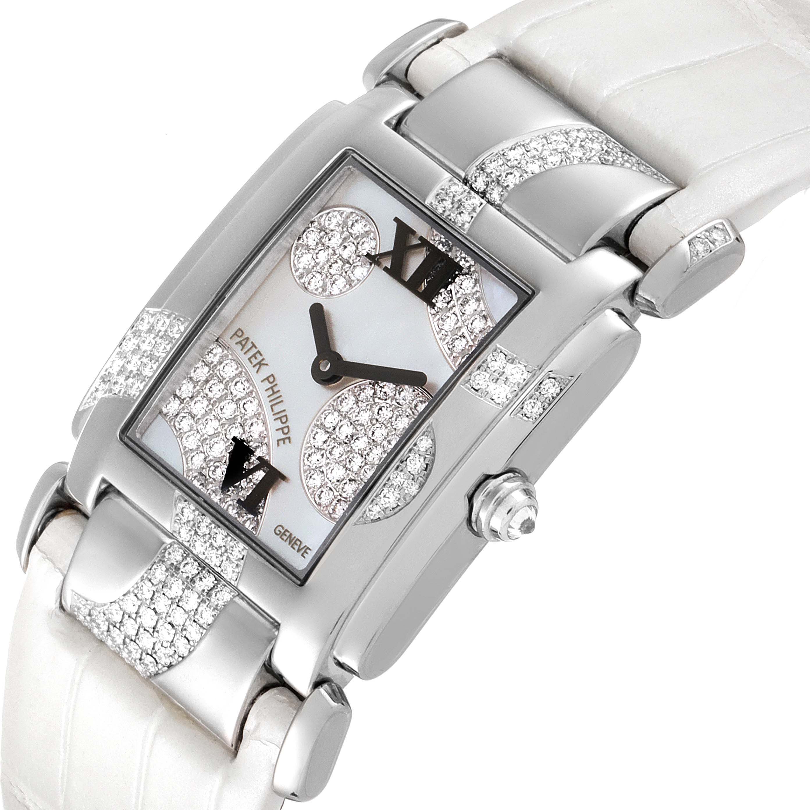 The image shows a Patek Philippe Twenty-4 4914G-001 Women's White Gold Mother of Pearl Dial 4914G-001 Women's White Gold Mother of Pearl Dial watch at an angle, highlighting the dial, bezel, and strap adorned with diamonds.