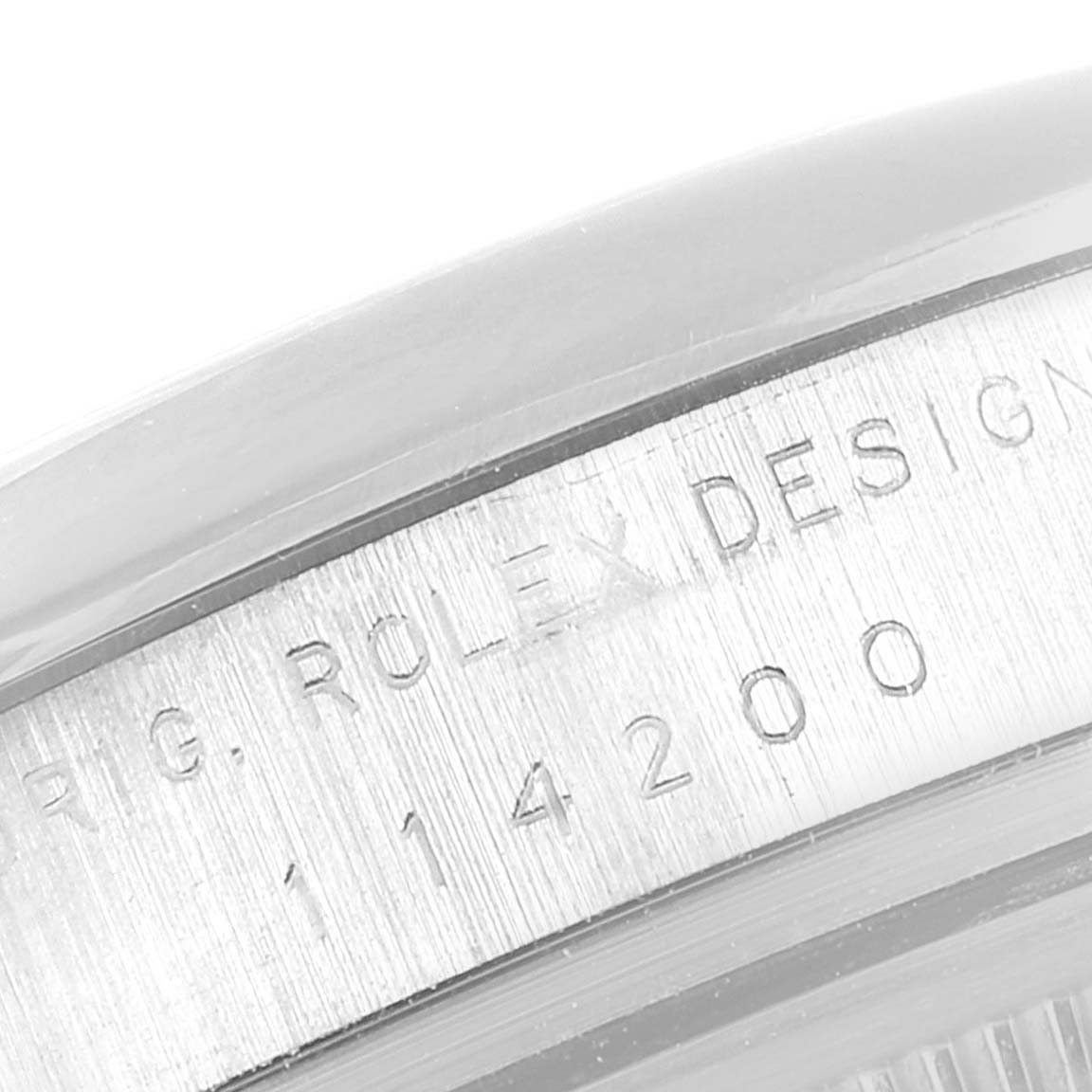 This image shows an angled close-up of the case back engraving on a Rolex Air-King 114200 Men's Stainless Steel Silver Dial 114200 Men's Stainless Steel Silver Dial model.