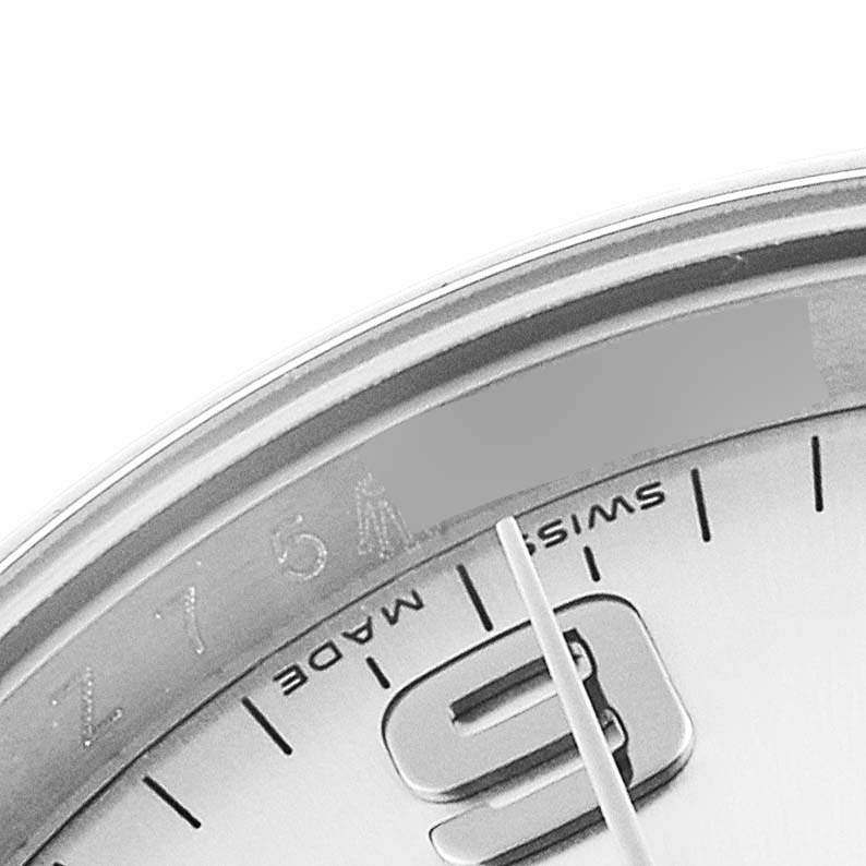 This close-up image shows a partial view of the Rolex Air-King 114200 Men's Stainless Steel Silver Dial 114200 Men's Stainless Steel Silver Dial watch dial including the number 9 marker and Swiss Made inscription.