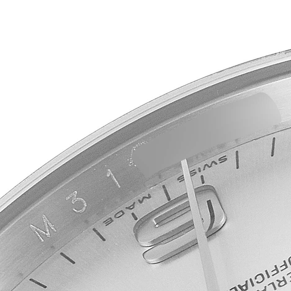 This image shows a close-up of the outer rim and part of the dial of a Rolex Air-King 114200 Men's Stainless Steel Silver Dial 114200 Men's Stainless Steel Silver Dial watch, including the "Swiss Made" text and markers.