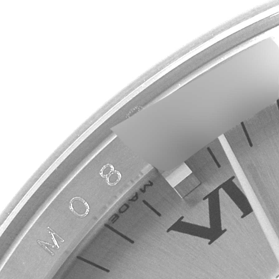 The image shows a close-up angled view of a Rolex Air-King 114200 Men's Stainless Steel Grey Dial 114200 Men's Stainless Steel Grey Dial watch face, highlighting part of the dial and case edge.