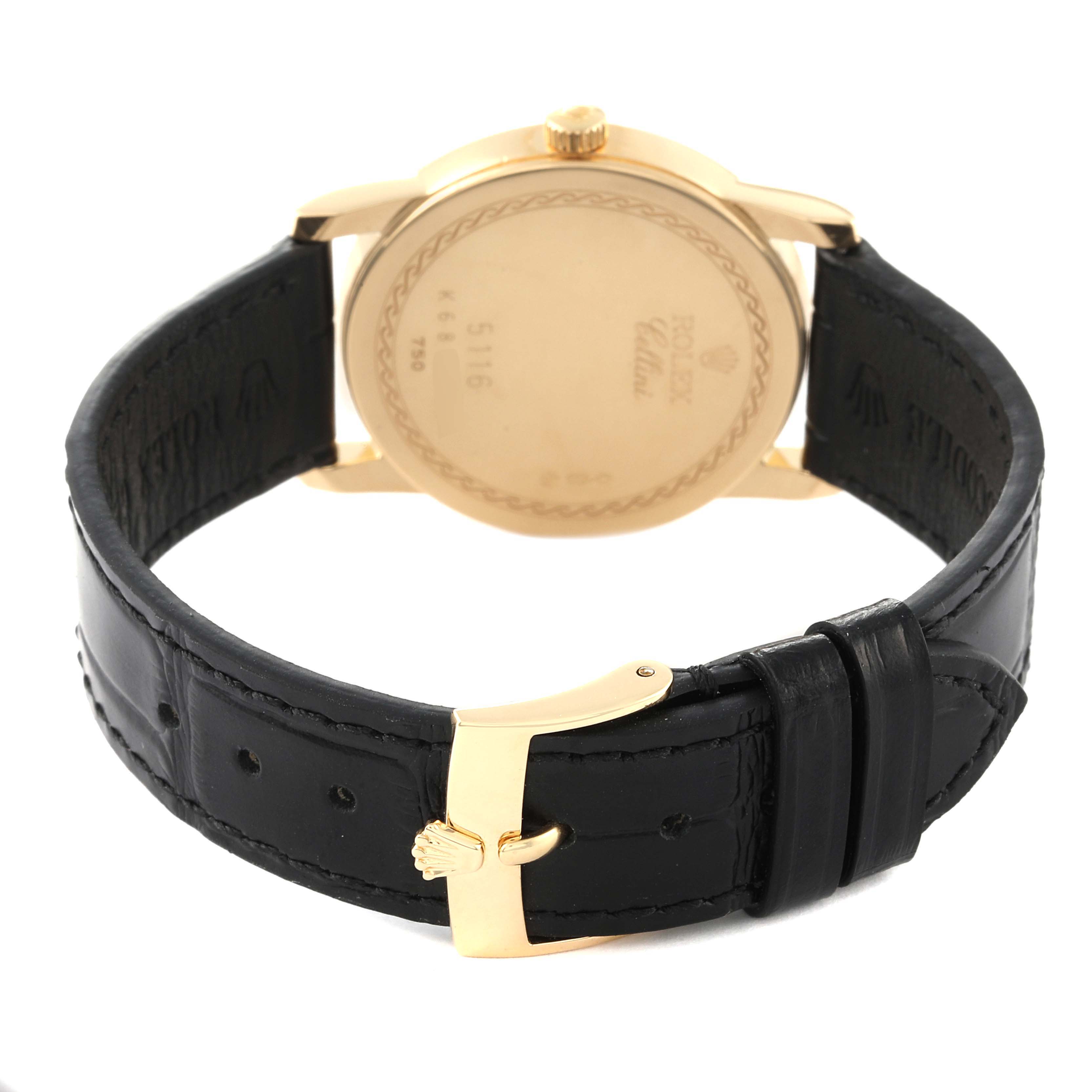 The image shows the back view of a Rolex Cellini 5116 Men
s Yellow Gold Champagne Dial 5116 Men
s Yellow Gold Champagne Dial watch with its black leather strap and gold clasp.