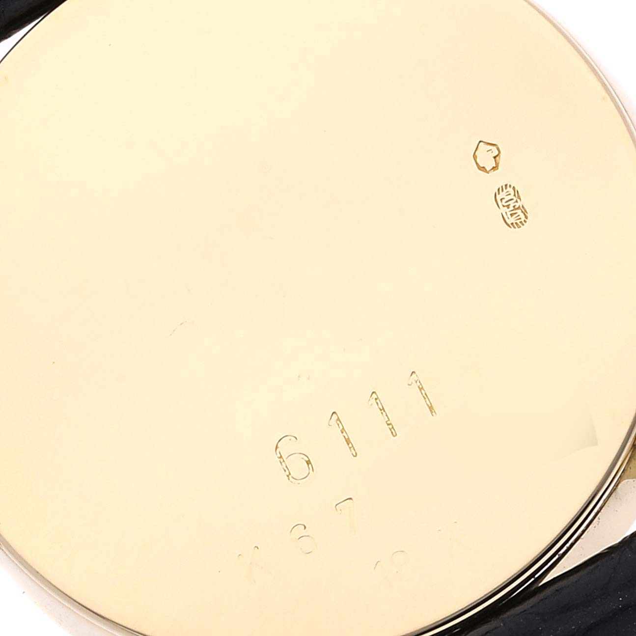 The image shows the back case of a Rolex Cellini 6111 Women's Yellow Gold Grey Dial 6111 Women's Yellow Gold Grey Dial watch, highlighting its engravings.