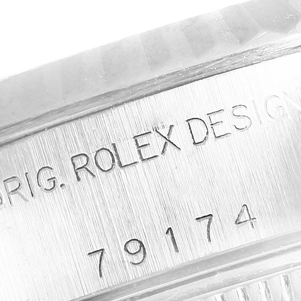 The image shows a close-up of the engraved serial number on the side of a Rolex Datejust 79174 Women's Stainless Steel Silver Dial 79174 Women's Stainless Steel Silver Dial watch.