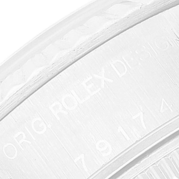 The image shows a close-up of the engraving on the side of the bezel of a Rolex Datejust 79174 Women's Stainless Steel Silver Dial 79174 Women's Stainless Steel Silver Dial model watch.