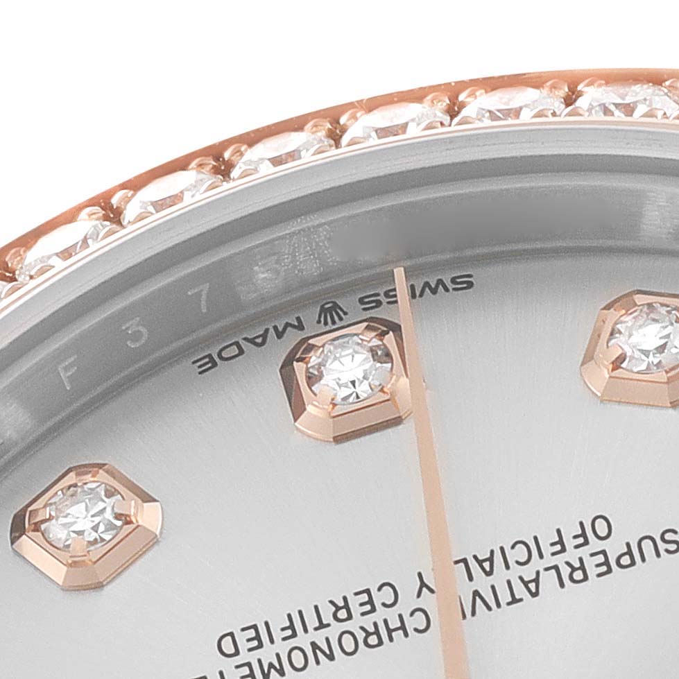This is a close-up angle of a Mid-Size Rolex watch showing part of the dial, with diamond hour markers and the "Swiss Made" label visible.