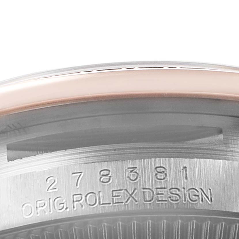 Close-up of the bezel and case edge of a Rolex Mid-Size 278381 Women
s Steel and Gold (two tone) Silver Dial 278381 Women
s Steel and Gold (two tone) Silver Dial model watch showing the serial number and "Orig. Rolex Design" engraving.