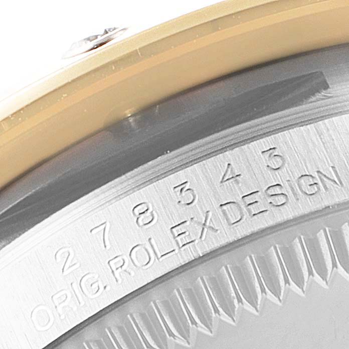 The image shows a close-up of the case back and edge markings of a Mid-Size Rolex watch.