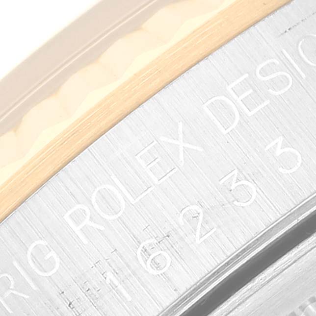 This image shows a close-up of the engraved writing on the side of the case of a Rolex Datejust 16233 Men's Steel and Gold (two tone) Black Dial 16233 Men's Steel and Gold (two tone) Black Dial watch.