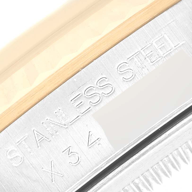 This image shows a close-up of the side of a Rolex Datejust 16233 Men's Steel and Gold (two tone) Black Dial 16233 Men's Steel and Gold (two tone) Black Dial model's bezel, highlighting the "STAINLESS STEEL" engraving.