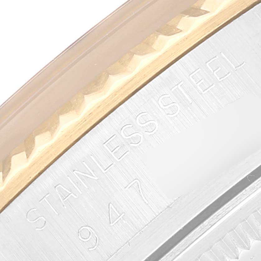 This close-up angle shows the side view of a Rolex Datejust 16013 Men's Steel and Gold (two tone) Black Dial 16013 Men's Steel and Gold (two tone) Black Dial watch, including the bezel and "STAINLESS STEEL" engraving.