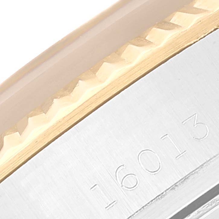 The image shows a close-up of the fluted bezel and case side with reference number 16013 of a Rolex Datejust 16013 Men's Steel and Gold (two tone) Black Dial 16013 Men's Steel and Gold (two tone) Black Dial watch.