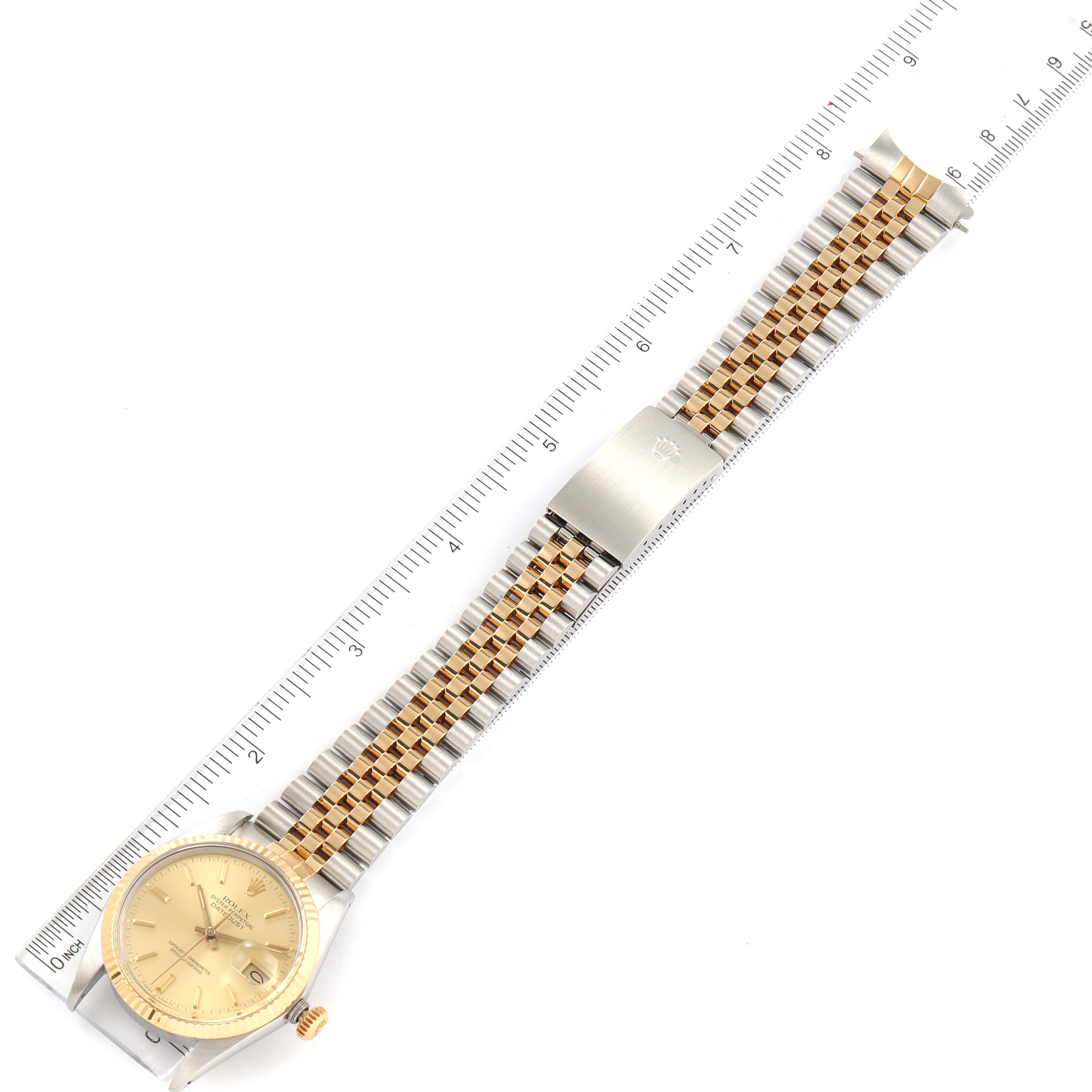 The Rolex Vintage Collection 16013 Men's Steel and Gold (two tone) Champagne Dial 16013 Men's Steel and Gold (two tone) Champagne Dial model is shown from a top-down angle, displaying the full face, bracelet, and clasp alongside a ruler for scale.