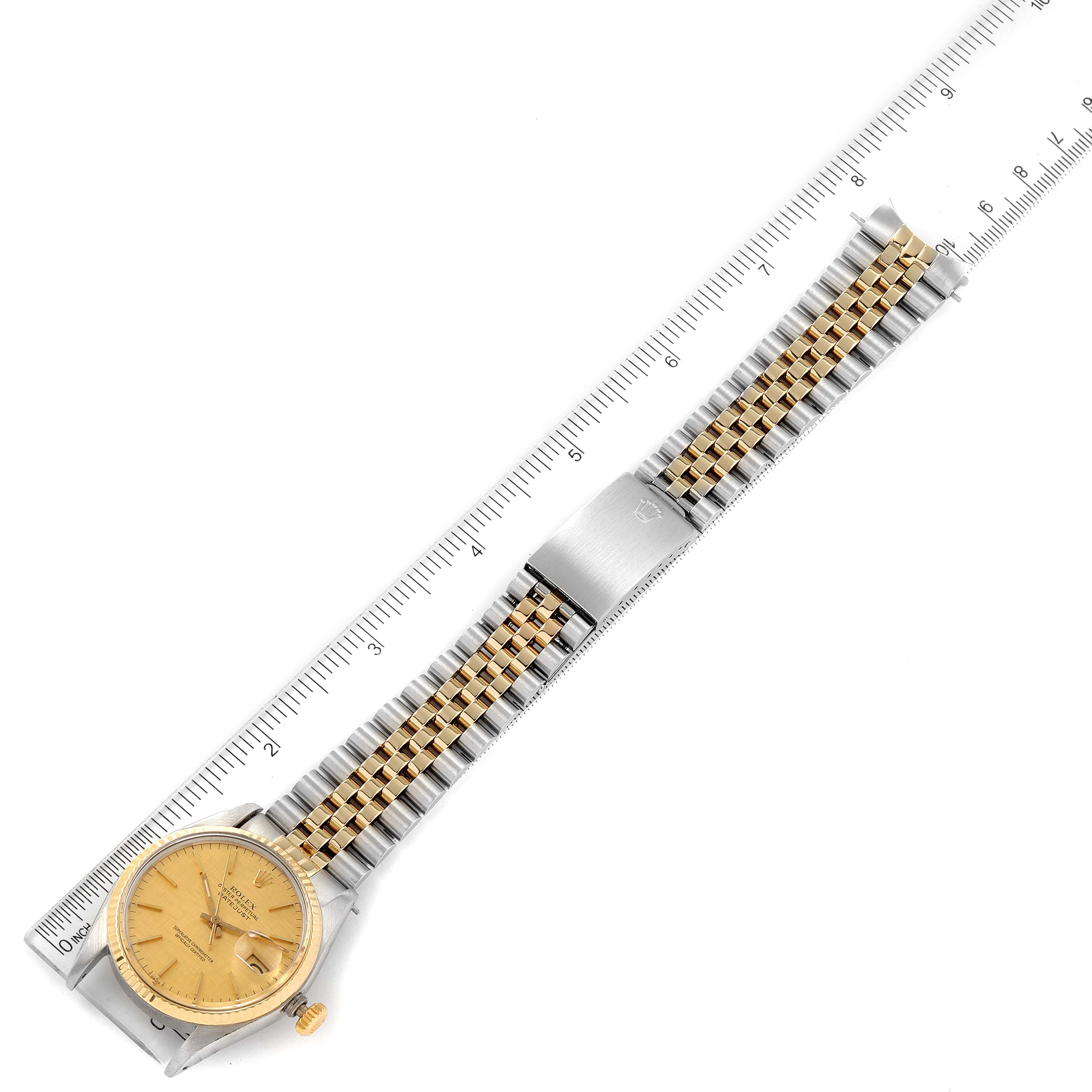 This image shows a top-down view of a Rolex Vintage Collection 16013 Men's Steel and Gold (two tone) Champagne Dial 16013 Men's Steel and Gold (two tone) Champagne Dial watch with a two-tone metal band, positioned next to a ruler.