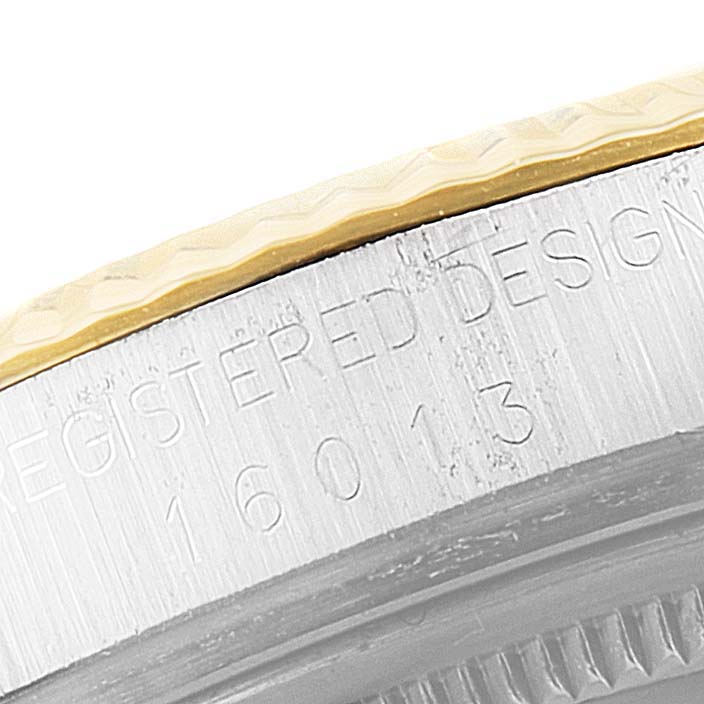 This close-up image shows the side of a Rolex Vintage Collection 16013 Men's Steel and Gold (two tone) Champagne Dial 16013 Men's Steel and Gold (two tone) Champagne Dial model, featuring part of its bezel and engraved markings.