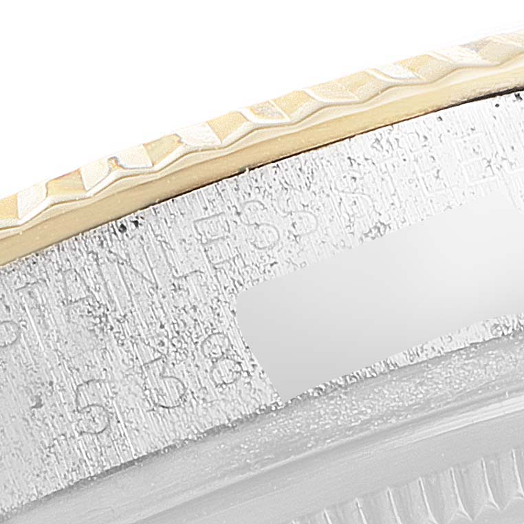 This close-up shows the edge and engravings on the bezel of a Vintage Collection Rolex watch.
