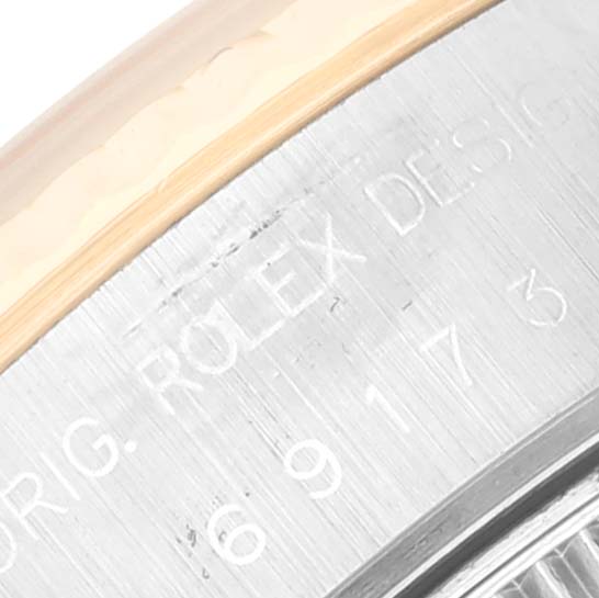 This close-up image shows the side engraving of a Rolex Datejust 69173 Women's Steel and Gold (two tone) White Dial 69173 Women's Steel and Gold (two tone) White Dial watch, focusing on the bezel and case back.