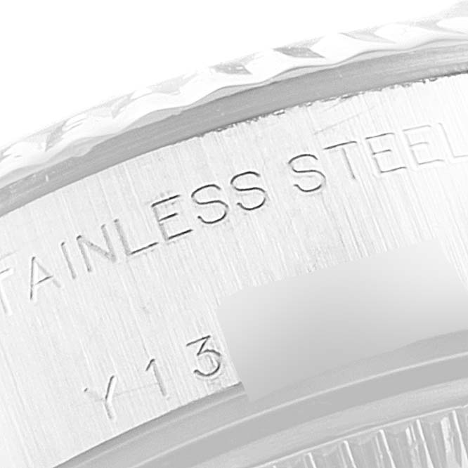 Close-up view of the stainless steel engraved bezel and part of the fluted edge of a Rolex Datejust 79174 Women's Stainless Steel Blue Dial 79174 Women's Stainless Steel Blue Dial.