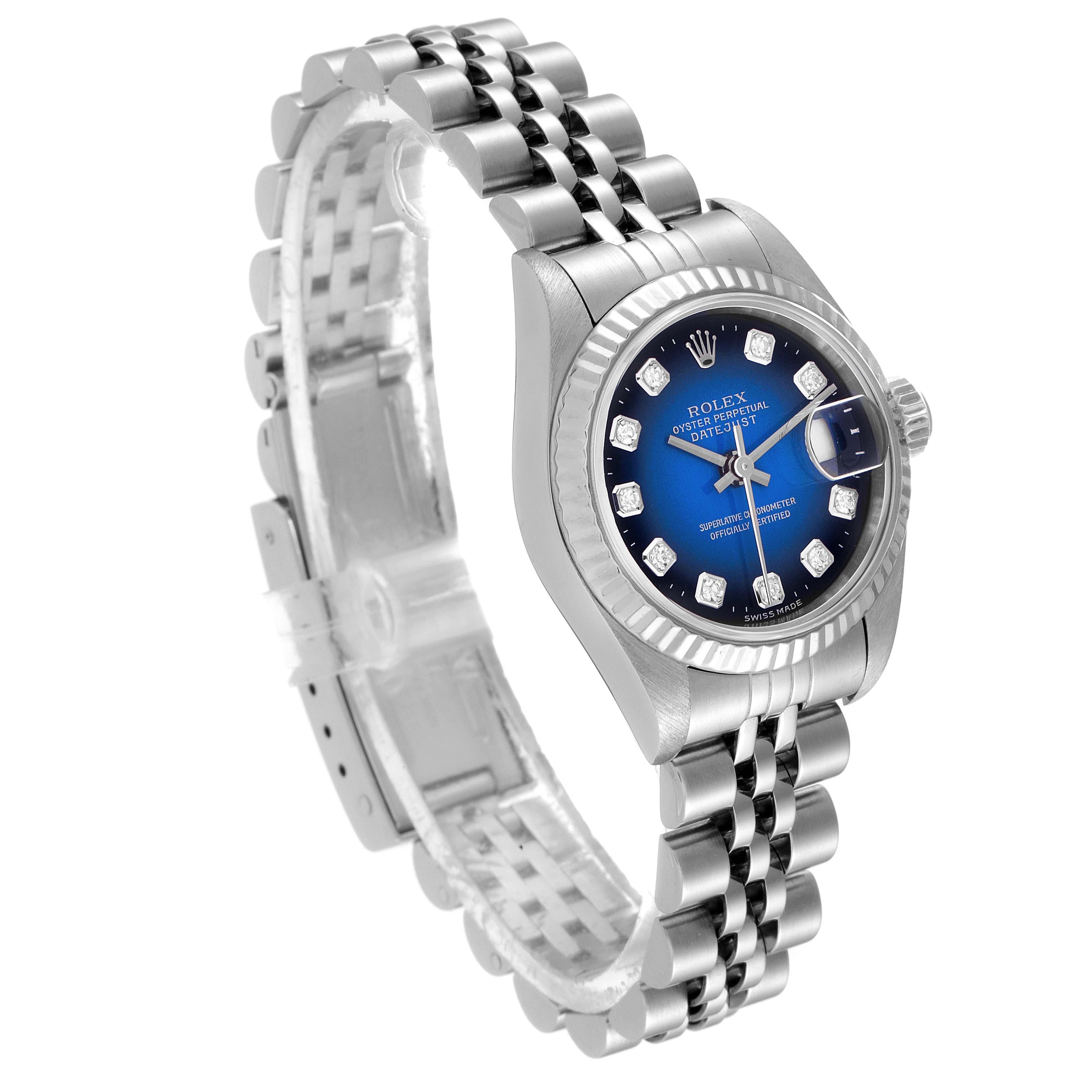 The image shows a side view of a Rolex Datejust 79174 Women's Stainless Steel Blue Dial 79174 Women's Stainless Steel Blue Dial watch showcasing its blue dial, fluted bezel, and jubilee bracelet.