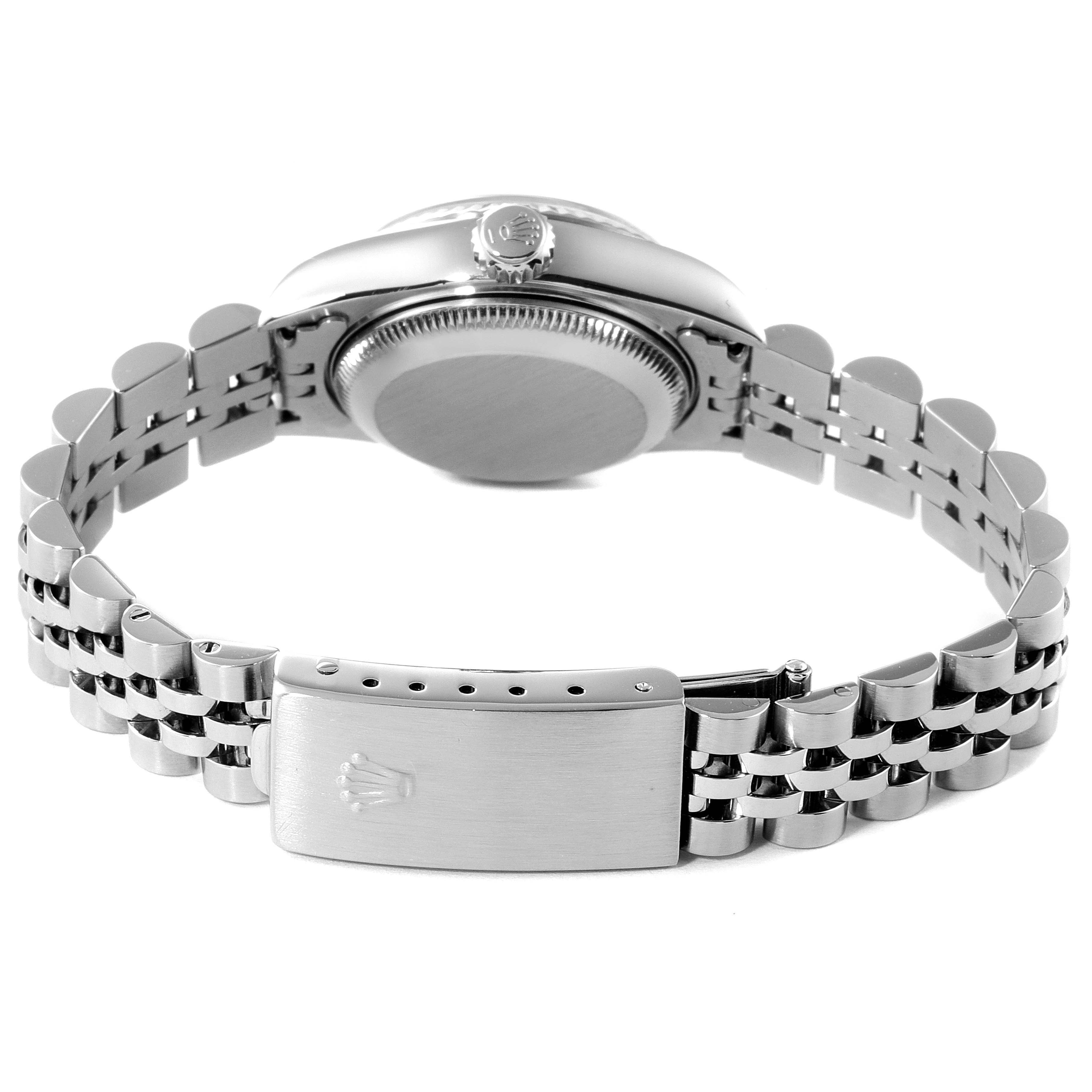 The Rolex Datejust 79174 Women's Stainless Steel Blue Dial 79174 Women's Stainless Steel Blue Dial watch is shown from a rear angle, highlighting the caseback, crown, and bracelet clasp with the Rolex logo.