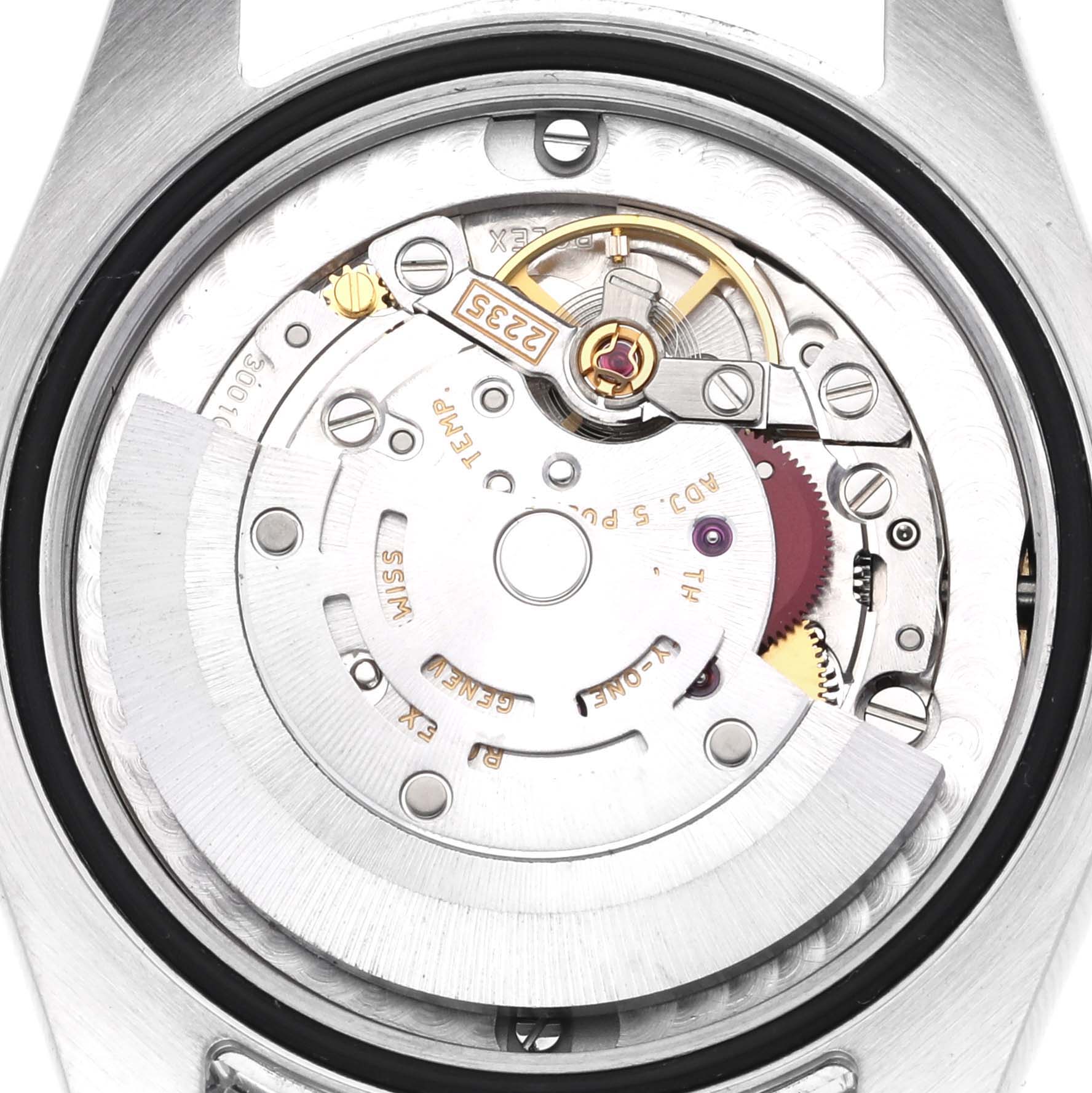 The image shows a close-up of the movement of a mid-size Rolex watch from the back.