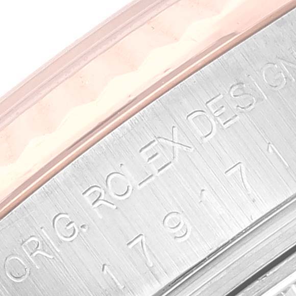 The image shows an extreme close-up of the side engraving on the bezel of a Rolex Datejust 179171 Women's Steel and Gold (two tone) Pink Dial 179171 Women's Steel and Gold (two tone) Pink Dial watch.