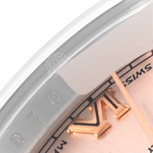 This image shows a close-up of the Rolex Datejust 179171 Women's Steel and Gold (two tone) Pink Dial 179171 Women's Steel and Gold (two tone) Pink Dial watch, focusing on part of the bezel and dial, including a Roman numeral marker.