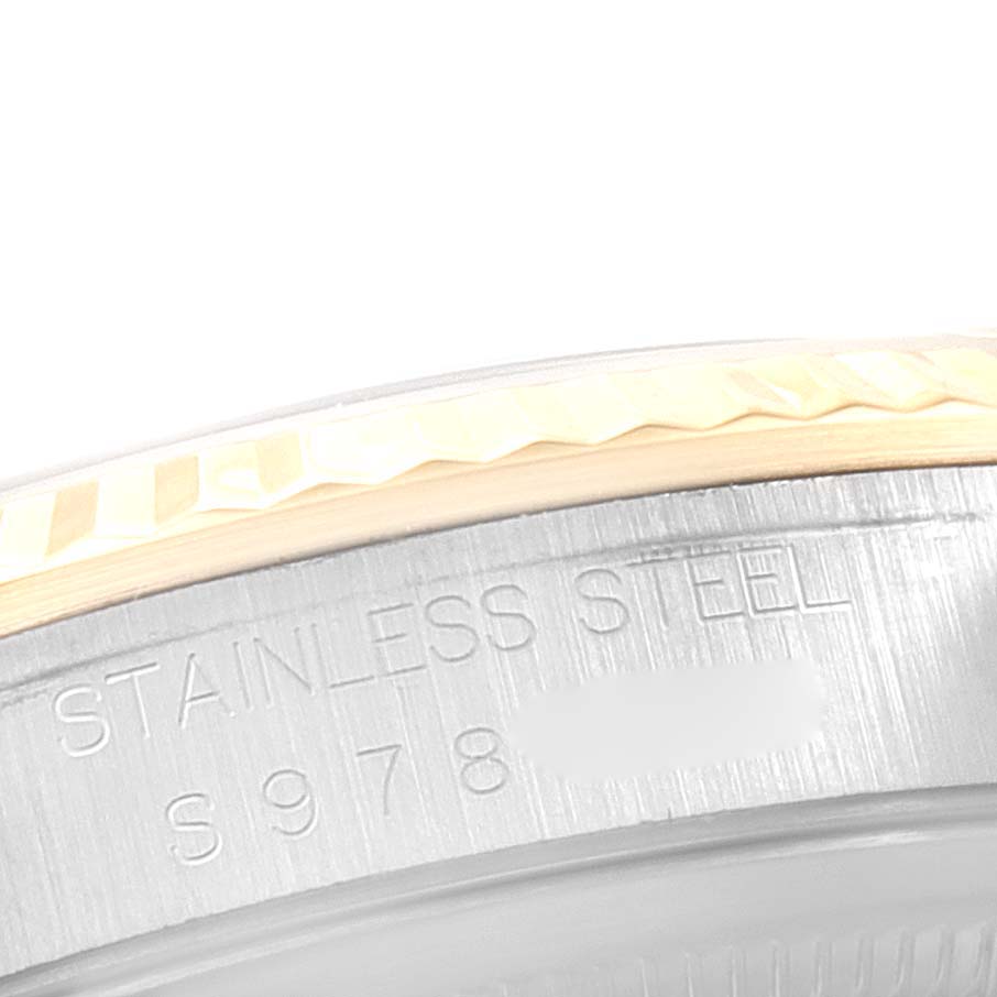 The image shows a close-up of the side engraving and fluted bezel of a Rolex Datejust 16233 Men's Steel and Gold (two tone) Champagne Dial 16233 Men's Steel and Gold (two tone) Champagne Dial watch with "STAINLESS STEEL" visible.