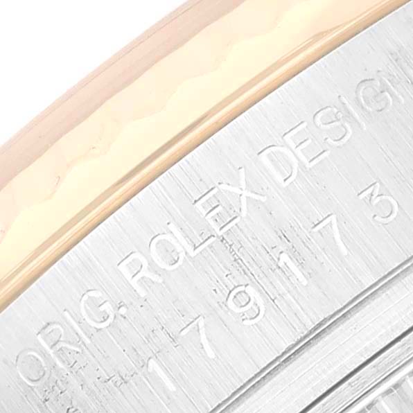 The image shows a close-up of the etched bezel and case of a Rolex Datejust 179173G Women's Steel and Gold (two tone) Silver Dial 179173G Women's Steel and Gold (two tone) Silver Dial watch.