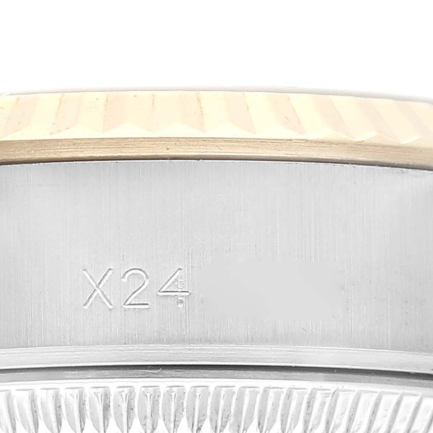 The image shows a close-up of the case and fluted bezel of a Rolex Datejust 69173 Women's Steel and Gold (two tone) Champagne Dial 69173 Women's Steel and Gold (two tone) Champagne Dial watch with visible markings.