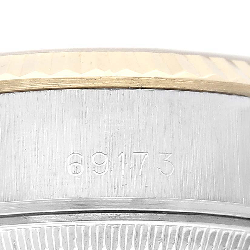 This close-up image of a Rolex Datejust 69173 Women's Steel and Gold (two tone) Champagne Dial 69173 Women's Steel and Gold (two tone) Champagne Dial watch shows the side of the case with the model number 69173 engraved.