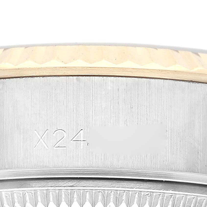 This image shows the case side and part of the fluted bezel of a Rolex Datejust 69173G Women's Steel and Gold (two tone) Champagne Dial 69173G Women's Steel and Gold (two tone) Champagne Dial watch with visible engravings.