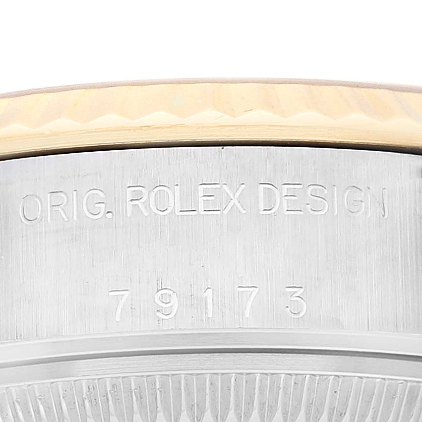The image shows a close-up of the case side of a Rolex Datejust 79173G Women's Steel and Gold (two tone) Champagne Dial 79173G Women's Steel and Gold (two tone) Champagne Dial, focusing on the engraved "ORIG. ROLEX DESIGN" text and model number 79173.
