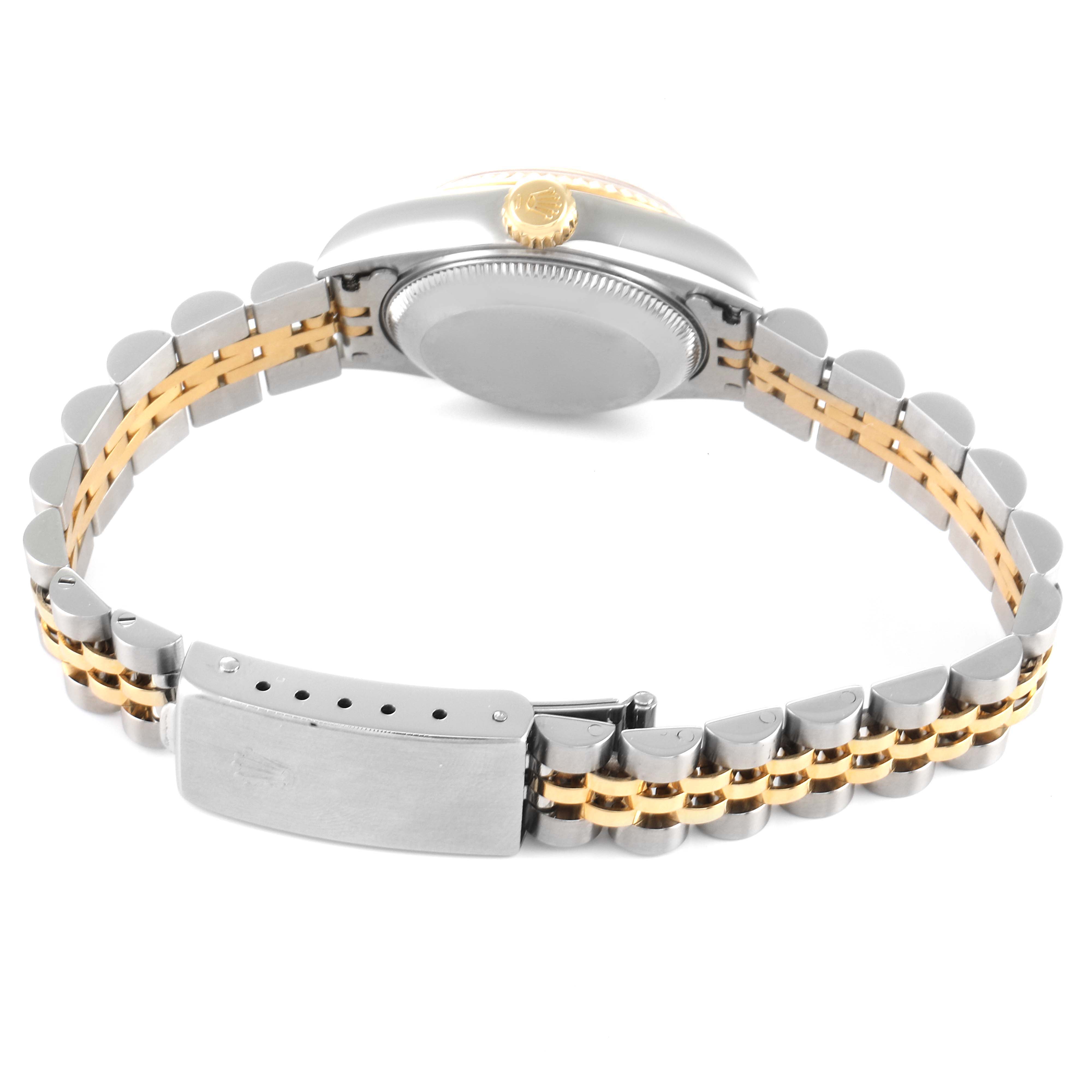 The image shows the underside of a Rolex Datejust 79173 Women's Steel and Gold (two tone) Champagne Dial 79173 Women's Steel and Gold (two tone) Champagne Dial watch, highlighting the clasp, case back, and bracelet with gold and silver links.