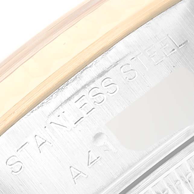 The image shows a close-up of the Rolex Datejust 79173G Women's Steel and Gold (two tone) Grey Dial 79173G Women's Steel and Gold (two tone) Grey Dial model's case rim and bezel, including "STAINLESS STEEL" engraving.