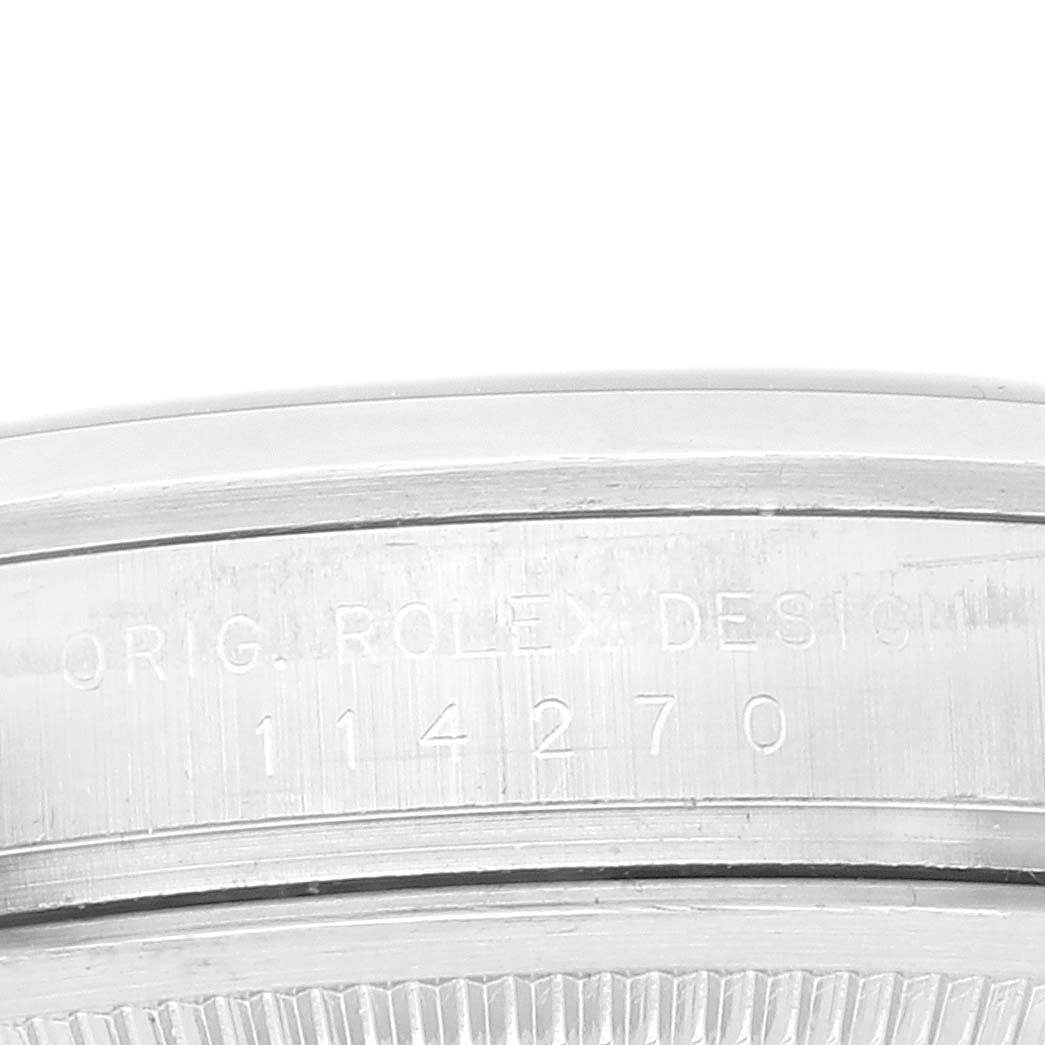 This close-up shows the engraved case back of the Rolex Explorer 114270 Men
s Stainless Steel Black Dial 114270 Men
s Stainless Steel Black Dial model with its reference number 114270.