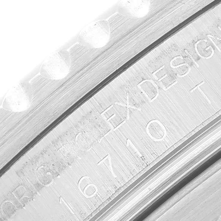 This close-up image shows the model number 16710 and part of the bezel for a Rolex GMT-Master 16710 Men's Stainless Steel Black Dial 16710 Men's Stainless Steel Black Dial watch.
