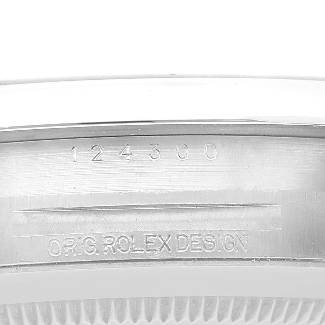 The image shows a close-up of the serial number and design engraving on the caseback of a Rolex Oyster Perpetual 124300 Men's Stainless Steel Silver Dial 124300 Men's Stainless Steel Silver Dial watch.