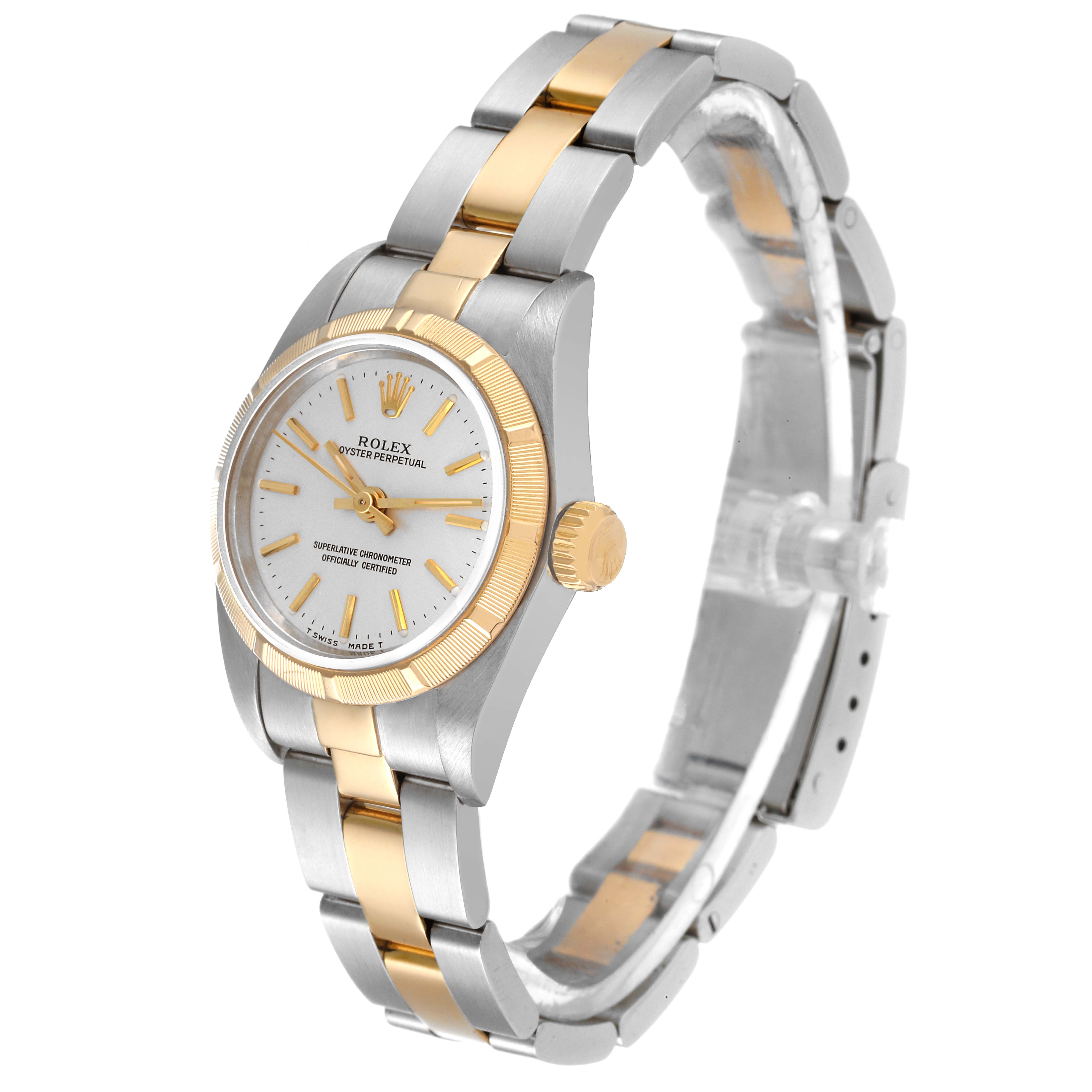 This image shows a Rolex Oyster Perpetual 67233 Women's Steel and Gold (two tone) Silver Dial 67233 Women's Steel and Gold (two tone) Silver Dial watch from an angled view highlighting its face, bezel, crown, and bracelet.