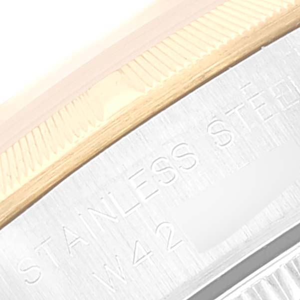 This image shows a close-up of the stainless steel and gold bezel of a Rolex Oyster Perpetual 67233 Women's Steel and Gold (two tone) Silver Dial 67233 Women's Steel and Gold (two tone) Silver Dial watch.