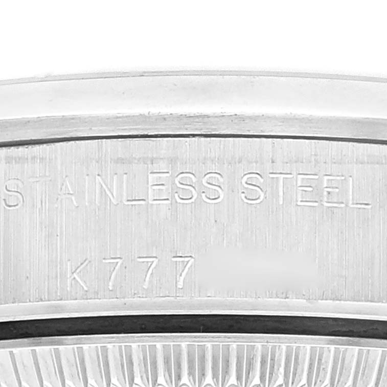 This close-up image shows the stainless steel engraving and a portion of the case back rim for the Rolex Oyster Perpetual 76080 Women
s Stainless Steel Pink Dial 76080 Women
s Stainless Steel Pink Dial watch.