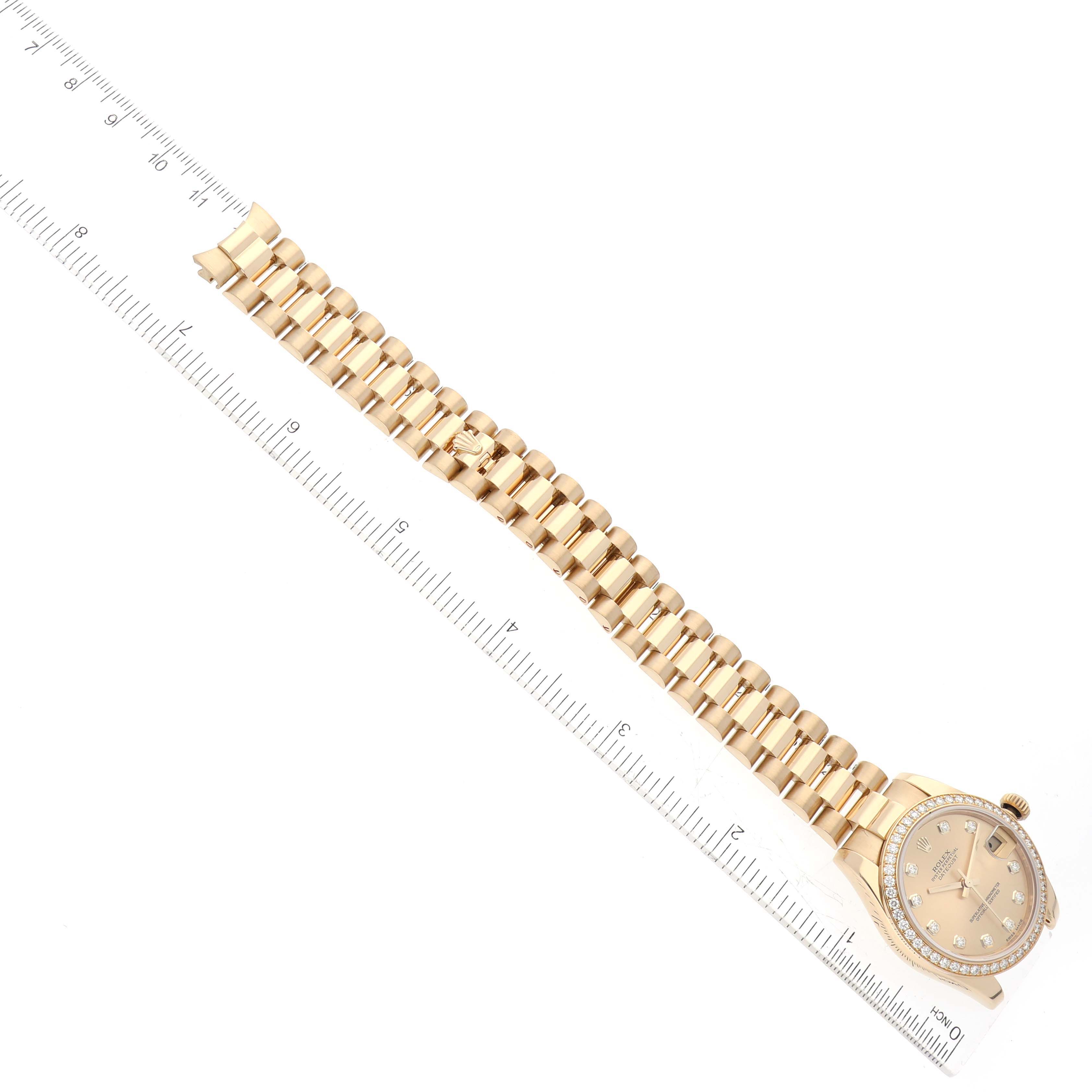 The Rolex President 178288 Women's Yellow Gold Champagne Dial 178288 Women's Yellow Gold Champagne Dial model watch is shown from a top-down angle, displaying the full bracelet and dial against a white background with a ruler alongside.