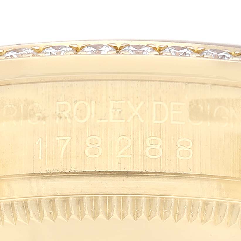The image shows a close-up of the bezel and case edge of a Rolex President 178288 Women's Yellow Gold Champagne Dial 178288 Women's Yellow Gold Champagne Dial 178288 watch, including an engraved serial number.